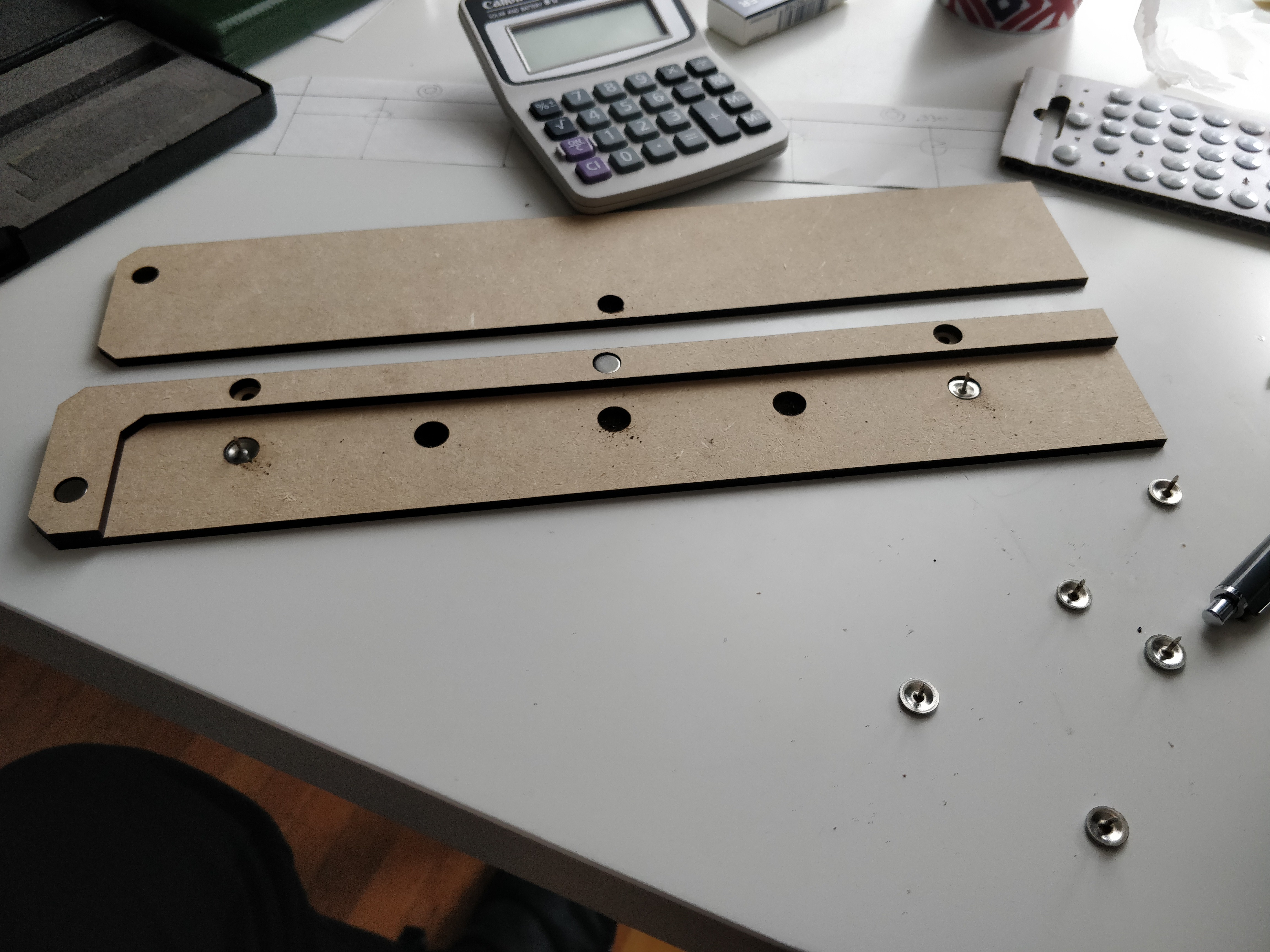 Recessed engravings hold thumbtacks that pierce the felt to hang it, and other laser machined recessses hold magnets to keep the front valance in place.