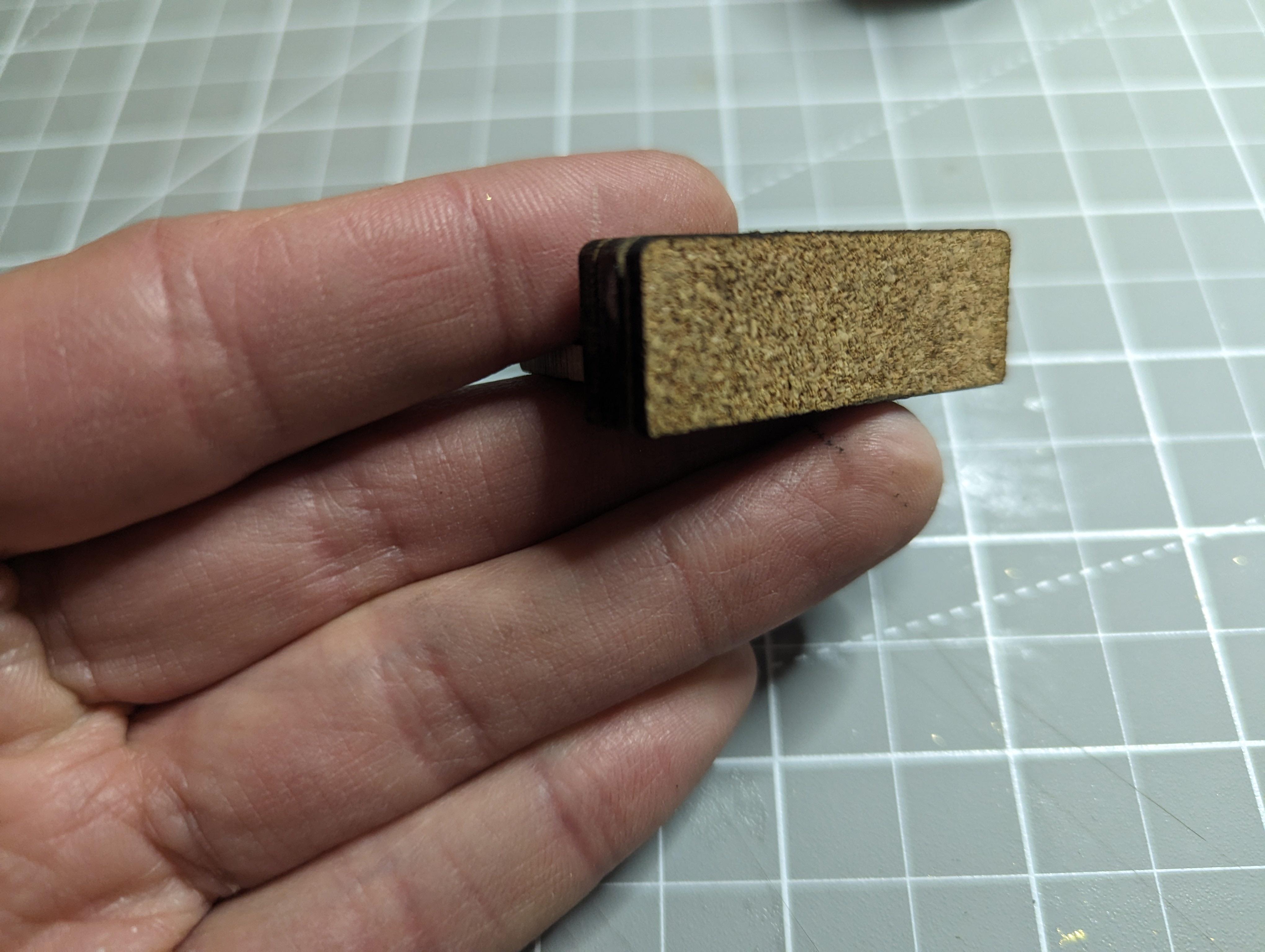 Cork backing to limit magnet, strength and protect gold leaf