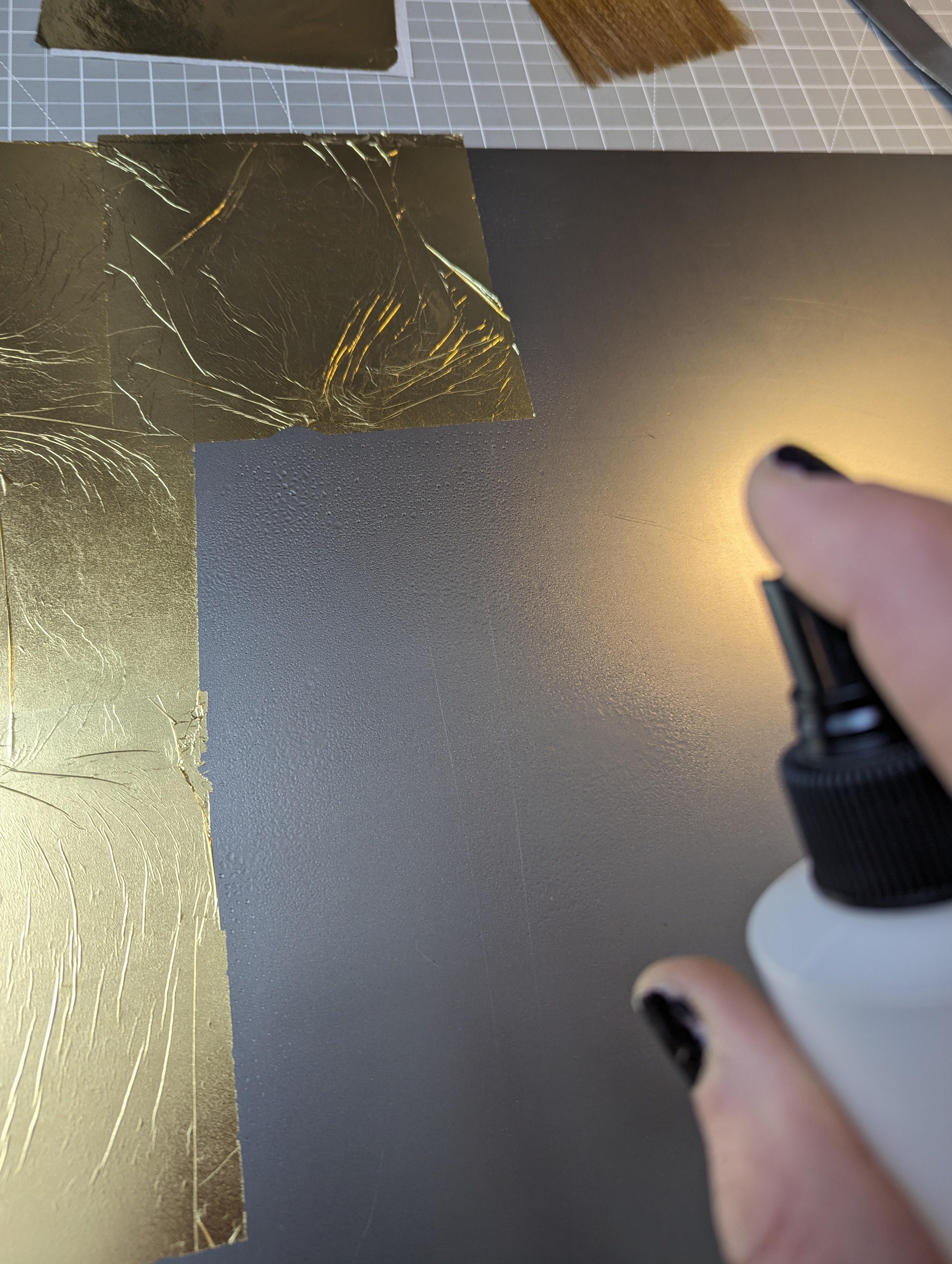 Spring solution to adhere gold leaf