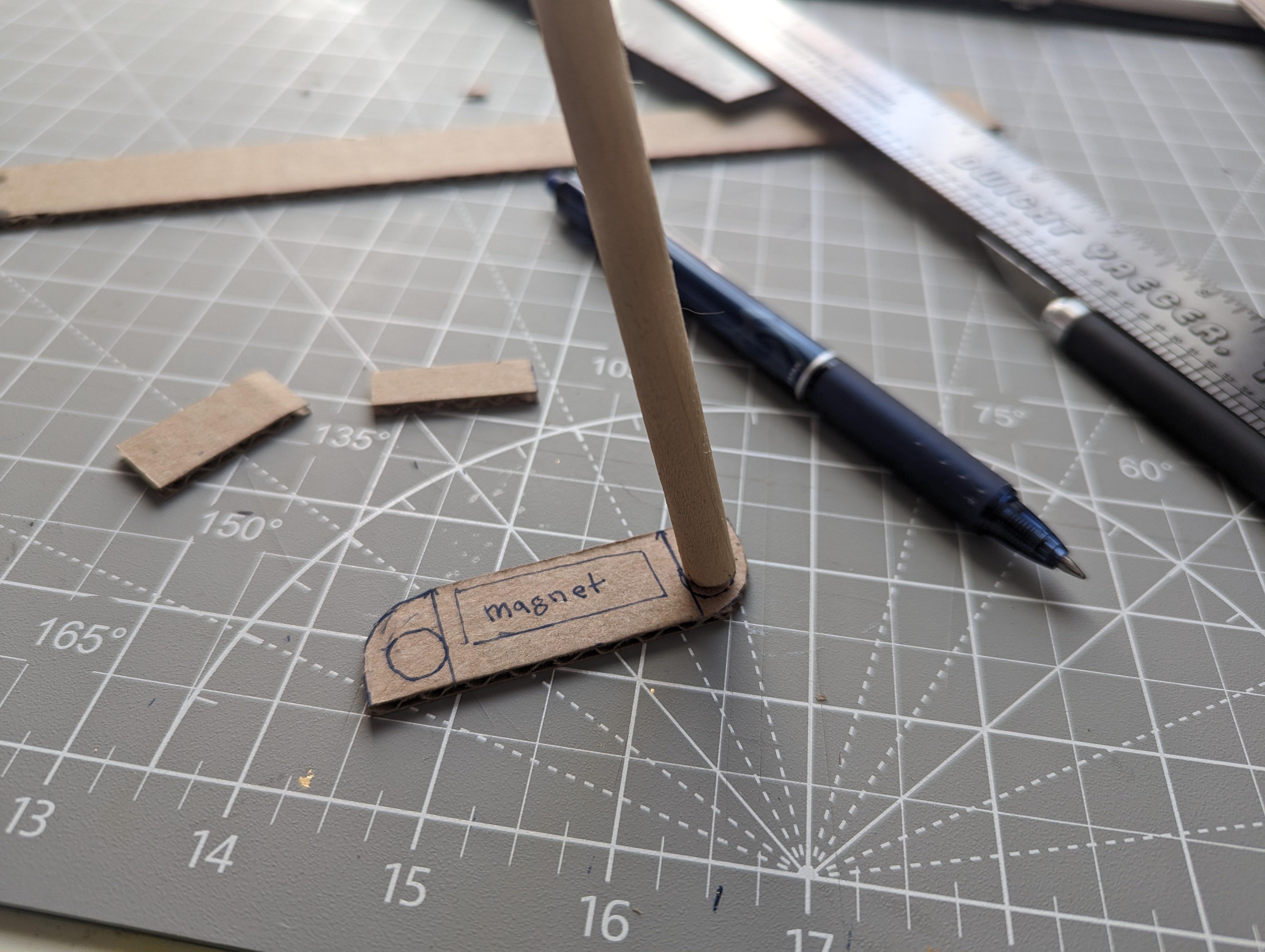 Using found. Dowel, rod and cardboard